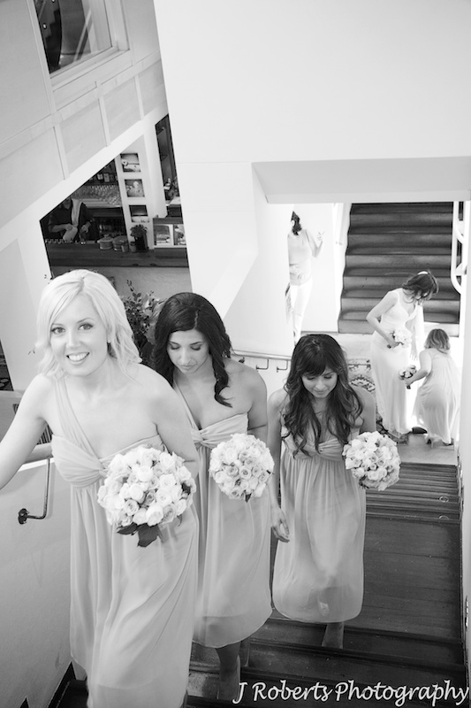 Bride and bridesmaid coming up the stairs for ceremony - wedding photography sydney